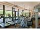 Well-equipped gym with treadmills, elliptical machines, televisions, and ample natural light from large windows at 7315 E Brisa Dr, Scottsdale, AZ 85266