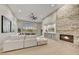 Elegant living room featuring a stone fireplace, neutral color palette, wood floors, and ample natural light at 7315 E Brisa Dr, Scottsdale, AZ 85266
