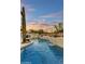 Lush backyard pool with serene waterfall feature, rock details, mature cacti and desert plantings under an open sky at 7315 E Brisa Dr, Scottsdale, AZ 85266