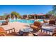 Community pool and lounge area with striped patio furniture for relaxation at 7315 E Brisa Dr, Scottsdale, AZ 85266