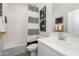 Modern bathroom featuring a shower-tub combo with stylish black and white accents and sleek fixtures at 7439 S 76Th Dr, Laveen, AZ 85339