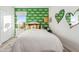 Inviting bedroom with a comfortable bed, stylish wallpaper, and ample natural light at 7439 S 76Th Dr, Laveen, AZ 85339