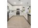 Modern kitchen with white cabinetry, stainless steel appliances, and a functional layout for cooking and entertaining at 7439 S 76Th Dr, Laveen, AZ 85339