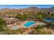 Community pool, a luxurious amenity, featuring a lap pool, spa, and lounge areas with mountain views at 7722 E Wolf Canyon St, Mesa, AZ 85207