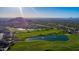 Aerial view of golf course with serene lakes and desert landscaping in a luxury community at 7722 E Wolf Canyon St, Mesa, AZ 85207