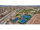 Aerial view of community with tennis courts, baseball fields, and walking paths, offering an active lifestyle at 7722 E Wolf Canyon St, Mesa, AZ 85207