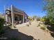 Backyard with covered patio, hammock, and desert landscaping, creating a peaceful outdoor retreat at 7722 E Wolf Canyon St, Mesa, AZ 85207