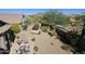 Aerial view of landscaped backyard featuring a hammock, patio, and mature desert plants at 7722 E Wolf Canyon St, Mesa, AZ 85207