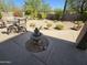 Landscaped backyard with a fountain and seating, perfect for outdoor relaxation and entertaining at 7722 E Wolf Canyon St, Mesa, AZ 85207