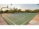 Community basketball court features well-maintained lines, hoops, and is surrounded by greenery, providing a fun, active space at 7722 E Wolf Canyon St, Mesa, AZ 85207