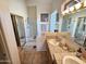 Bathroom with dual sinks, tile floors, walk-in shower, and bathtub at 7722 E Wolf Canyon St, Mesa, AZ 85207