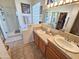 Bright bathroom features double sinks, walk-in shower, and a large mirror reflecting the closet at 7722 E Wolf Canyon St, Mesa, AZ 85207