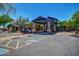 Elegant community center entrance featuring a porte cochere with stone accents and well-maintained landscaping at 7722 E Wolf Canyon St, Mesa, AZ 85207
