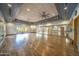 Spacious fitness room features hardwood floors, a mirrored wall, and exercise equipment with plenty of space for activities at 7722 E Wolf Canyon St, Mesa, AZ 85207