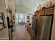 Bright kitchen features tile floors, wood cabinets, granite countertops, and stainless steel refrigerator at 7722 E Wolf Canyon St, Mesa, AZ 85207