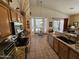 Bright kitchen features tile floors, wood cabinets, granite countertops, and garden view at 7722 E Wolf Canyon St, Mesa, AZ 85207