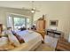 Main bedroom features vaulted ceilings, ensuite bathroom, and views of the green backyard at 7722 E Wolf Canyon St, Mesa, AZ 85207