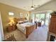 Main bedroom features vaulted ceilings, ensuite bathroom, and large windows overlooking green backyard at 7722 E Wolf Canyon St, Mesa, AZ 85207
