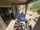 Covered patio with outdoor seating and sliding glass doors, overlooking the landscaped backyard at 7722 E Wolf Canyon St, Mesa, AZ 85207