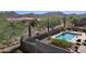Stunning backyard with a sparkling pool, lounge chairs, desert landscaping and mountain views at 7722 E Wolf Canyon St, Mesa, AZ 85207