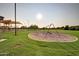 A covered playground and a swing set provide a safe and entertaining outdoor space for children to play at 7722 E Wolf Canyon St, Mesa, AZ 85207