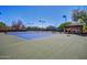 Multiple tennis courts with a covered lounge area provide a well-maintained and inviting space for residents to play at 7722 E Wolf Canyon St, Mesa, AZ 85207