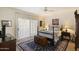 Serene bedroom with a four-poster bed, soft lighting, and a decorative chest on a patterned rug at 7955 E Chaparral Rd # 129, Scottsdale, AZ 85250