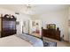 Spacious bedroom showcasing a four-poster bed, dresser, and doorway leading to other areas of the home at 7955 E Chaparral Rd # 129, Scottsdale, AZ 85250
