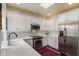 Bright kitchen with white cabinetry, stainless steel appliances, and modern finishes at 7955 E Chaparral Rd # 129, Scottsdale, AZ 85250