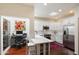 Modern kitchen with a breakfast bar, sleek countertops, and stainless steel appliances at 7955 E Chaparral Rd # 129, Scottsdale, AZ 85250