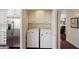 Convenient laundry area with washer, dryer, and ample white cabinetry, adjacent to a stainless steel refrigerator at 7955 E Chaparral Rd # 129, Scottsdale, AZ 85250