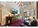 Inviting living room with vaulted ceilings, a ceiling fan, a media center, and comfortable leather seating at 7955 E Chaparral Rd # 129, Scottsdale, AZ 85250
