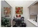 Bright office space featuring a desk, computer setup, and a colorful floral painting, near a white countertop at 7955 E Chaparral Rd # 129, Scottsdale, AZ 85250