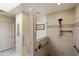 Accessible shower featuring grab bars, built-in shelving, and decorative tile accents with neutral tones at 7955 E Chaparral Rd # 129, Scottsdale, AZ 85250