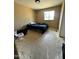 Spacious bedroom featuring a large window, neutral walls, and worn tile flooring ready for renovation at 8257 E Cypress St, Scottsdale, AZ 85257