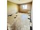 Bedroom showcasing neutral walls, patterned tile flooring with missing baseboards, and natural light at 8257 E Cypress St, Scottsdale, AZ 85257