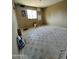 View of an empty bedroom showing neutral walls, tile flooring, and natural light through a window at 8257 E Cypress St, Scottsdale, AZ 85257