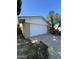 Exterior view of a well-maintained garage featuring a white door, gravel landscaping, and a convenient driveway at 8257 E Cypress St, Scottsdale, AZ 85257