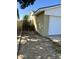 View of a garage exterior showing its side, gravel landscaping, a gate, and part of the adjacent home at 8257 E Cypress St, Scottsdale, AZ 85257