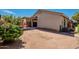 View of the backyard and exterior of a house with tan stucco and a tile roof at 8660 E Nido Ave, Mesa, AZ 85209