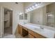 Bathroom with double sinks, tile floors, and walk in closet at 8660 E Nido Ave, Mesa, AZ 85209