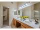 Bathroom with double sinks, tile floors, and walk in closet at 8660 E Nido Ave, Mesa, AZ 85209
