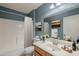 Bathroom featuring blue walls, a shower/tub, a mirror, and a sink at 8660 E Nido Ave, Mesa, AZ 85209