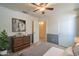 Bedroom featuring neutral paint, ceiling fan, walk-in closet, and attached ensuite at 8660 E Nido Ave, Mesa, AZ 85209