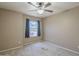 Bedroom featuring a window with natural light and a ceiling fan at 8660 E Nido Ave, Mesa, AZ 85209