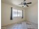 Bedroom with tile floors, a ceiling fan, and a window at 8660 E Nido Ave, Mesa, AZ 85209