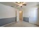 Bedroom featuring neutral paint, ceiling fan, walk-in closet, and attached ensuite at 8660 E Nido Ave, Mesa, AZ 85209