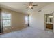 Bedroom featuring a ceiling fan, natural light, and an attached ensuite bathroom at 8660 E Nido Ave, Mesa, AZ 85209