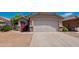 Charming home featuring a two-car garage, desert landscaping and stone veneer accents at 8660 E Nido Ave, Mesa, AZ 85209
