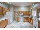 Kitchen features white appliances, tile floors, and plenty of cabinet space at 8660 E Nido Ave, Mesa, AZ 85209